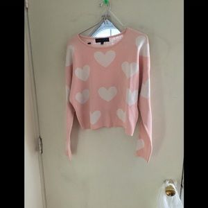 pink sweater with white hearts